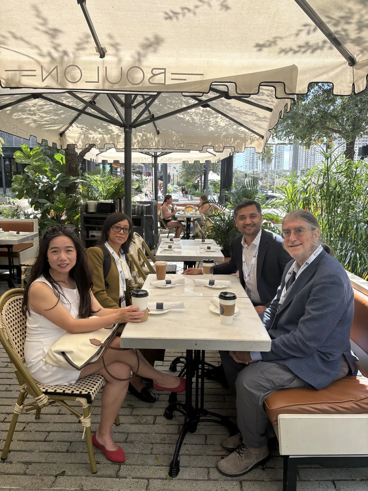 M. R. Hoque with Philip H. Dybvig and colleagues at an outdoor cafe in Tampa